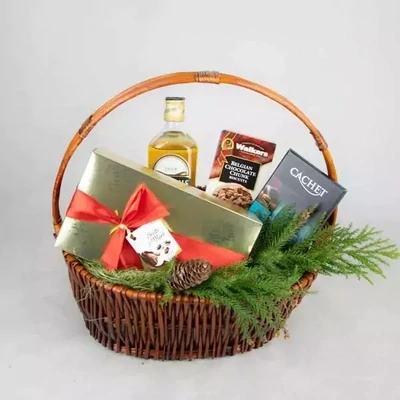 New Year basket with whiskey and sweets