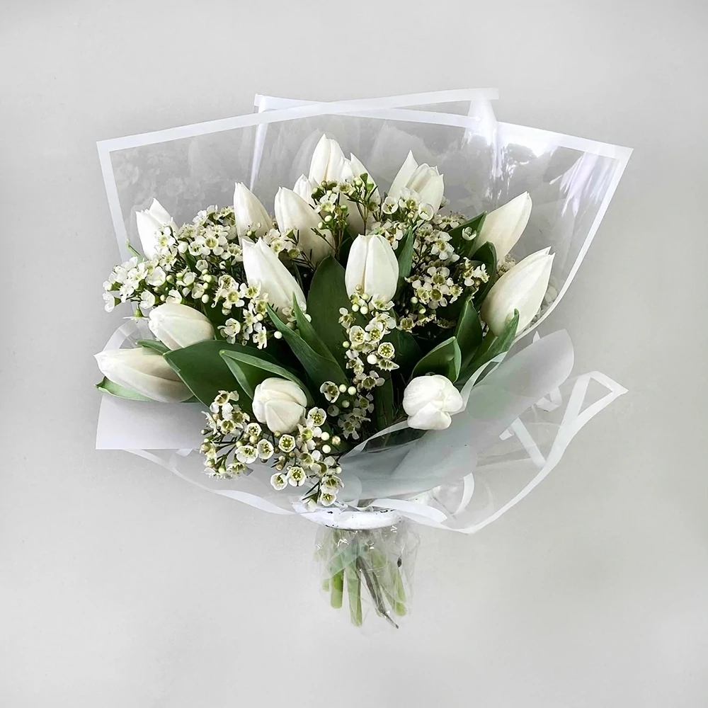 A bouquet of white tulips with Chamelacium