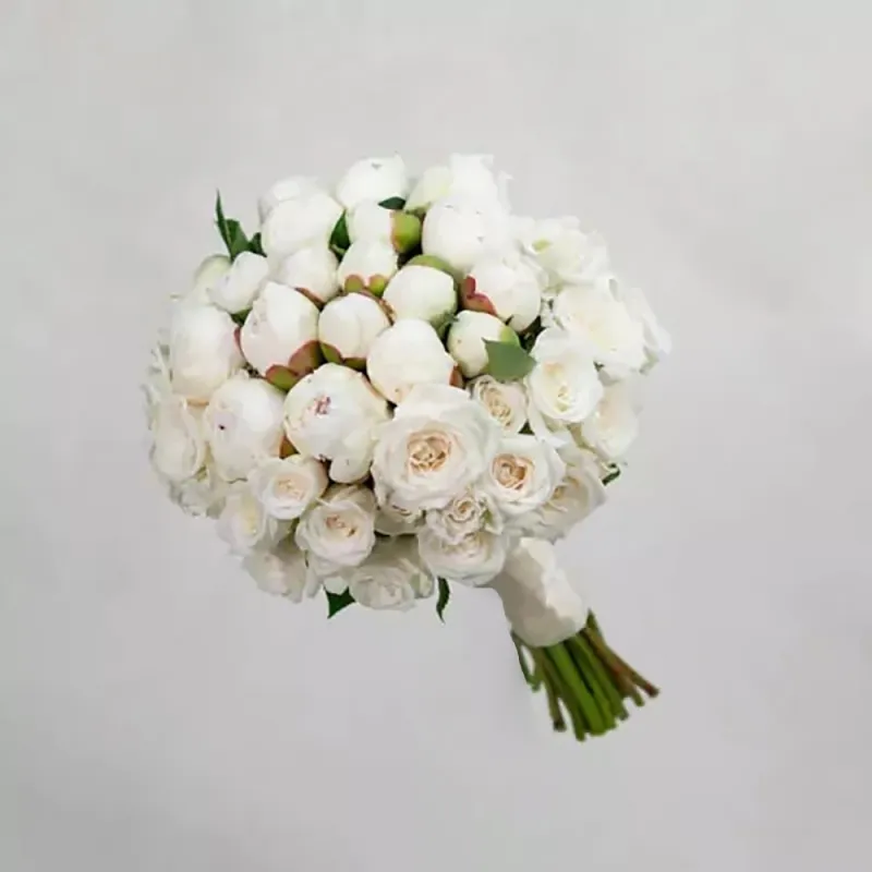 White peonies and white spray roses are used in the bridal bouquet