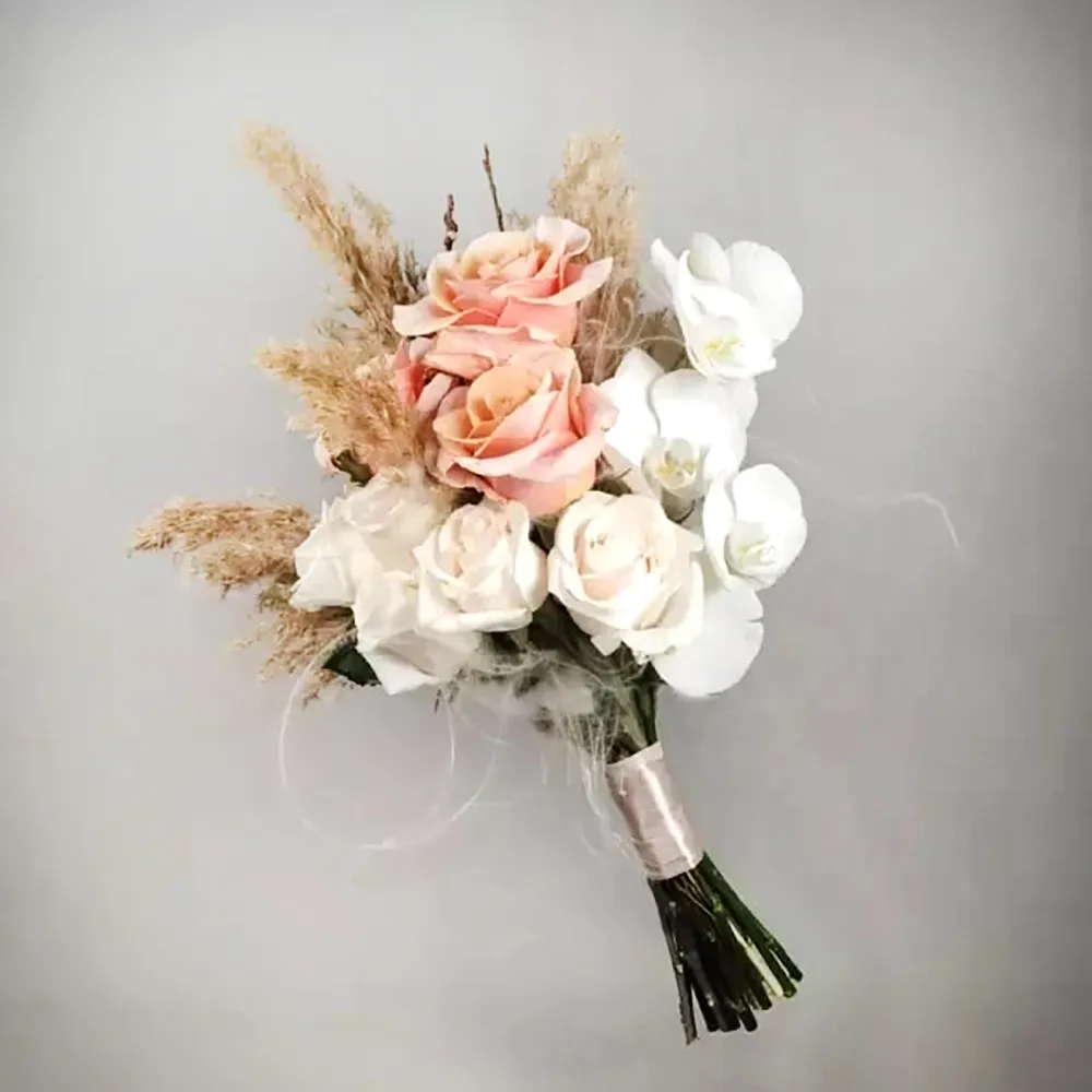 Asymmetric wedding bouquet with peach and white roses