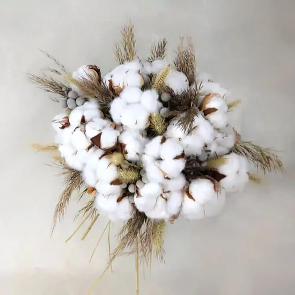 Wedding bouquet is made in white colors, cotton flower is used in this wedding bouquet.