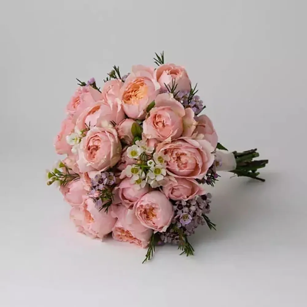 The wedding bouquet is made with pink spray roses