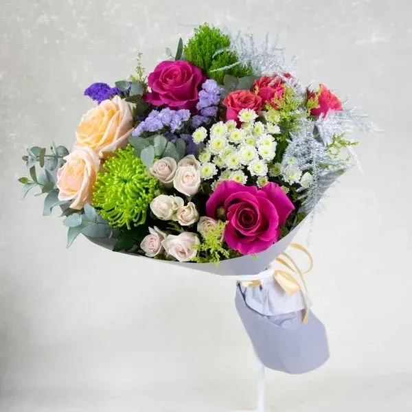 Mix bouquet made of roses and chrysanthemums in different colors.
