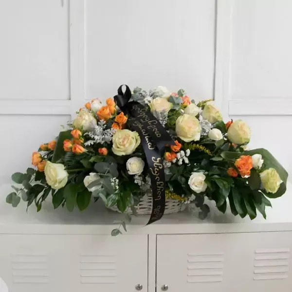 Funeral wreath with white roses and seasonal greenery. The approximate size of the given wreath is …