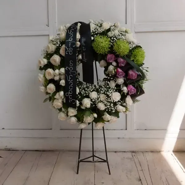 A large funeral wreath with roses with frame support. The average diameter of this wreath is 50 cen…