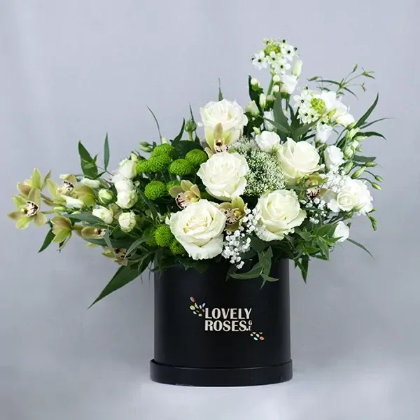 Funeral composition in white tones and a black box.