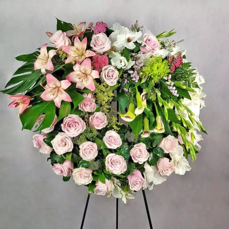 A large funeral wreath with different flowers, with frame support. The average diameter of this wre…