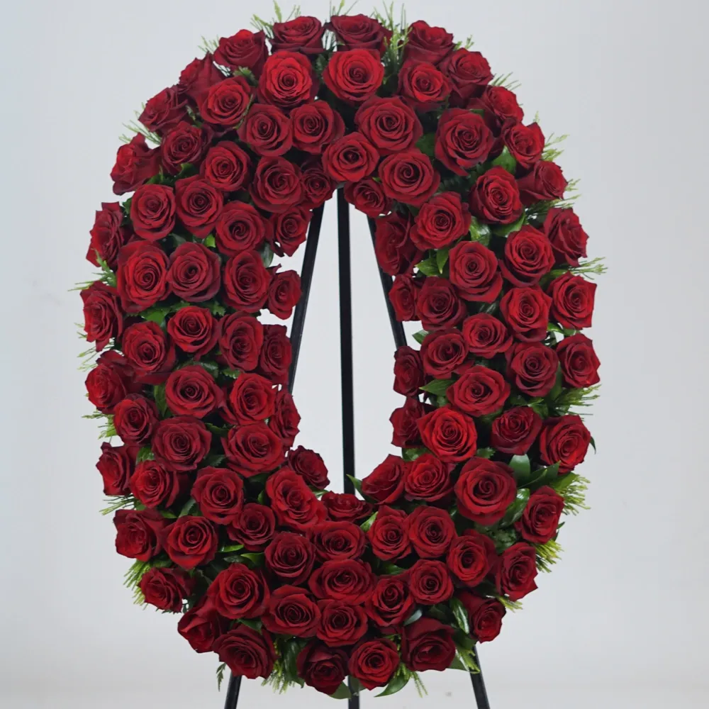Large oval funeral wreath with 100 red roses