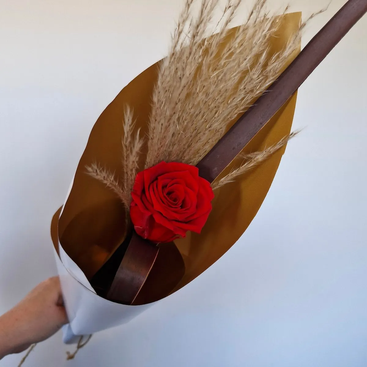 Close-up of one preserved red rose in the Forever Yours display.
