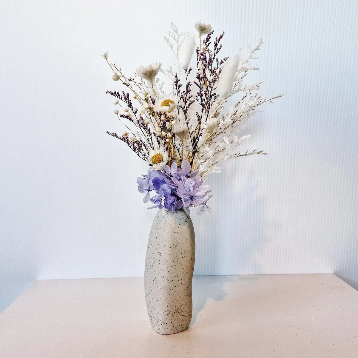 Glow dried floral arrangement in a Ned Collections Harmie Bud Vase, featuring radiant dried and preserved flowers.