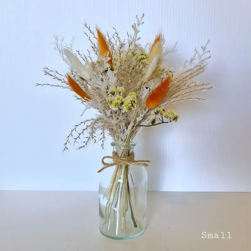 Hazel small dried floral arrangement in a clear glass bud vase, perfect as a simple wedding centerpiece or thoughtful gift.