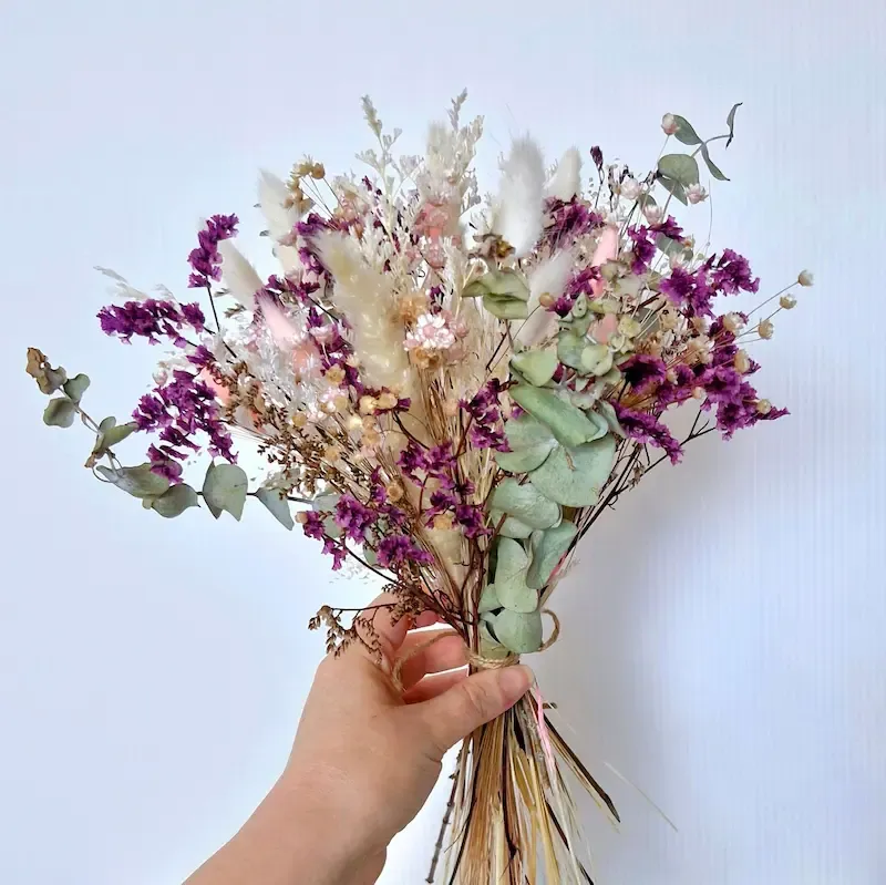 Hopeful pastel dried floral bouquet with bunny tails, gypsophila, star flowers, limonium, pampas, and eucalyptus.