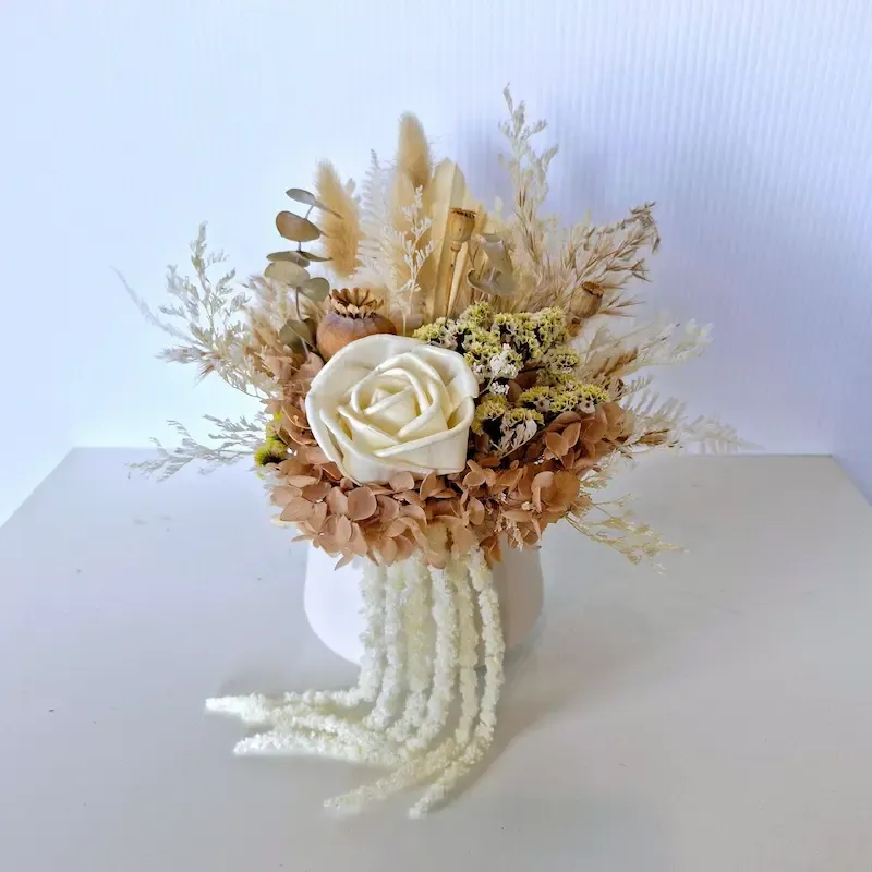 Ivory dried flowers in a white ceramic pot with hydrangea, sola roses, and greenery, perfect for home or gifts.
