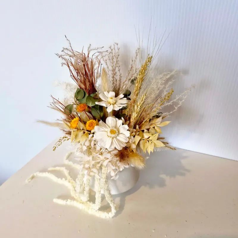 Top-down view of Adore dried flower arrangement showing mix of preserved flowers, wheat, and greenery.
