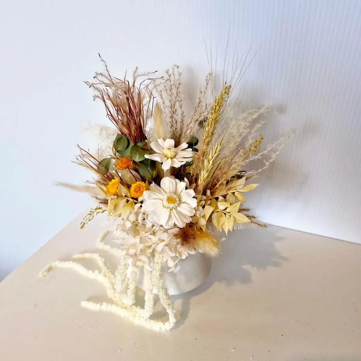Top-down view of Adore dried flower arrangement showing mix of preserved flowers, wheat, and greenery.