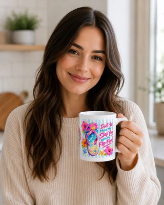 Woman holding a white ceramic flip-flop mug in a bright kitchen, decorated with tropical flowers, beach artwork, and a funny 