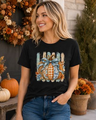 Woman wearing a black fall pumpkin graphic T-shirt with blue bow, floral, gingham, leopard, and toile patterns.