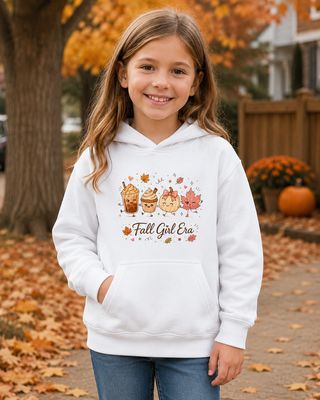 White girl wearing a white Fall Girl Era kids hoodie outdoors among autumn leaves and pumpkins.