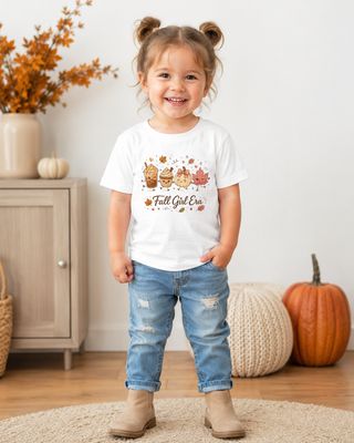 Toddler girl wearing a white Fall Girl Era T-shirt with cute autumn coffee, pumpkin, and leaf graphics.