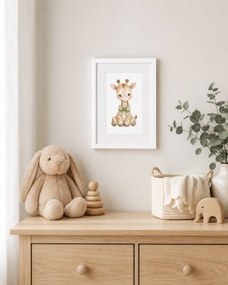 Framed watercolor giraffe print above a nursery dresser with a plush bunny and wooden toys.