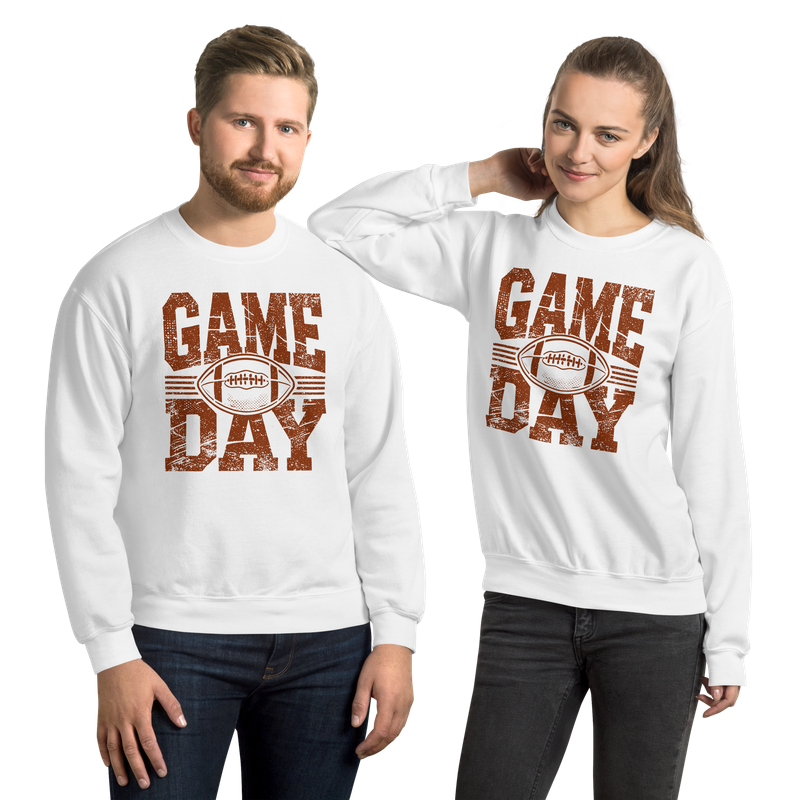 Man and woman wearing matching white Game Day football crewneck sweatshirts.