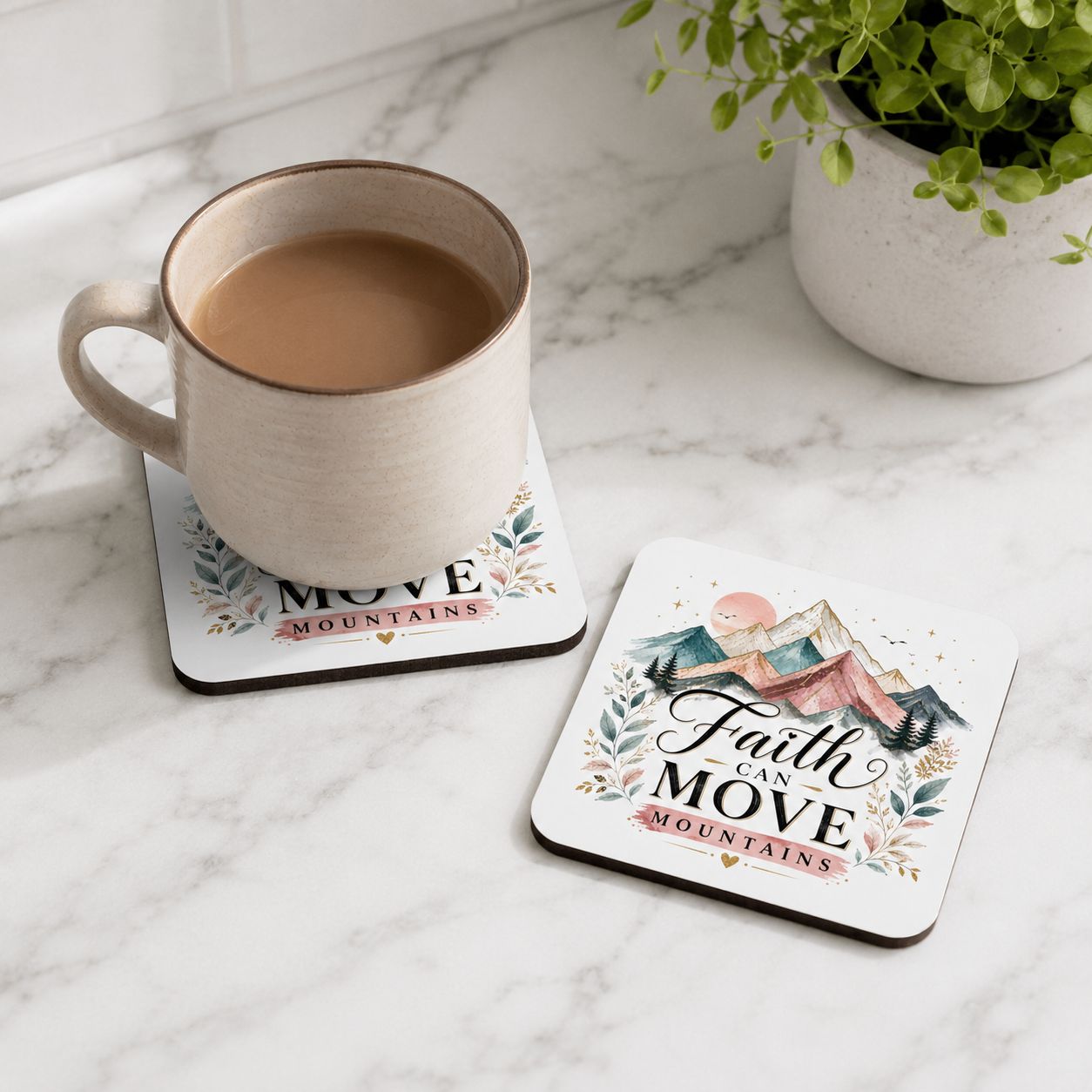 Faith Can Move Mountains coaster set on marble, with a cream coffee mug on one coaster and a second coaster beside it.