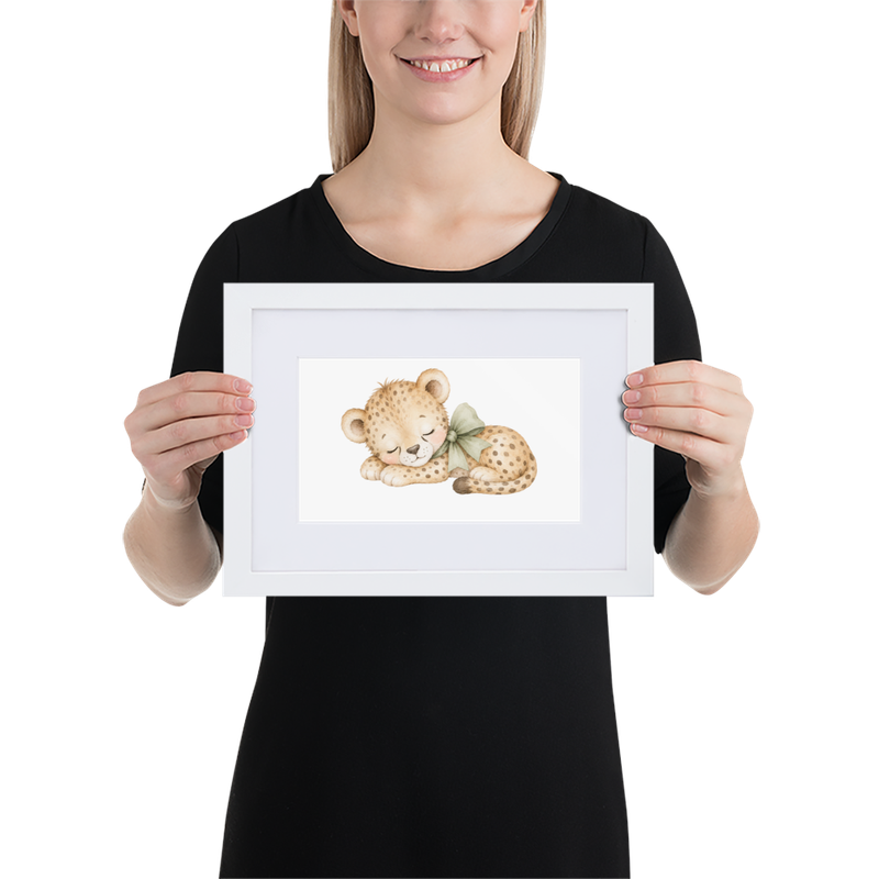 21 × 30 cm: White framed nursery print featuring a sleeping baby cheetah with a sage green bow, held by a woman.