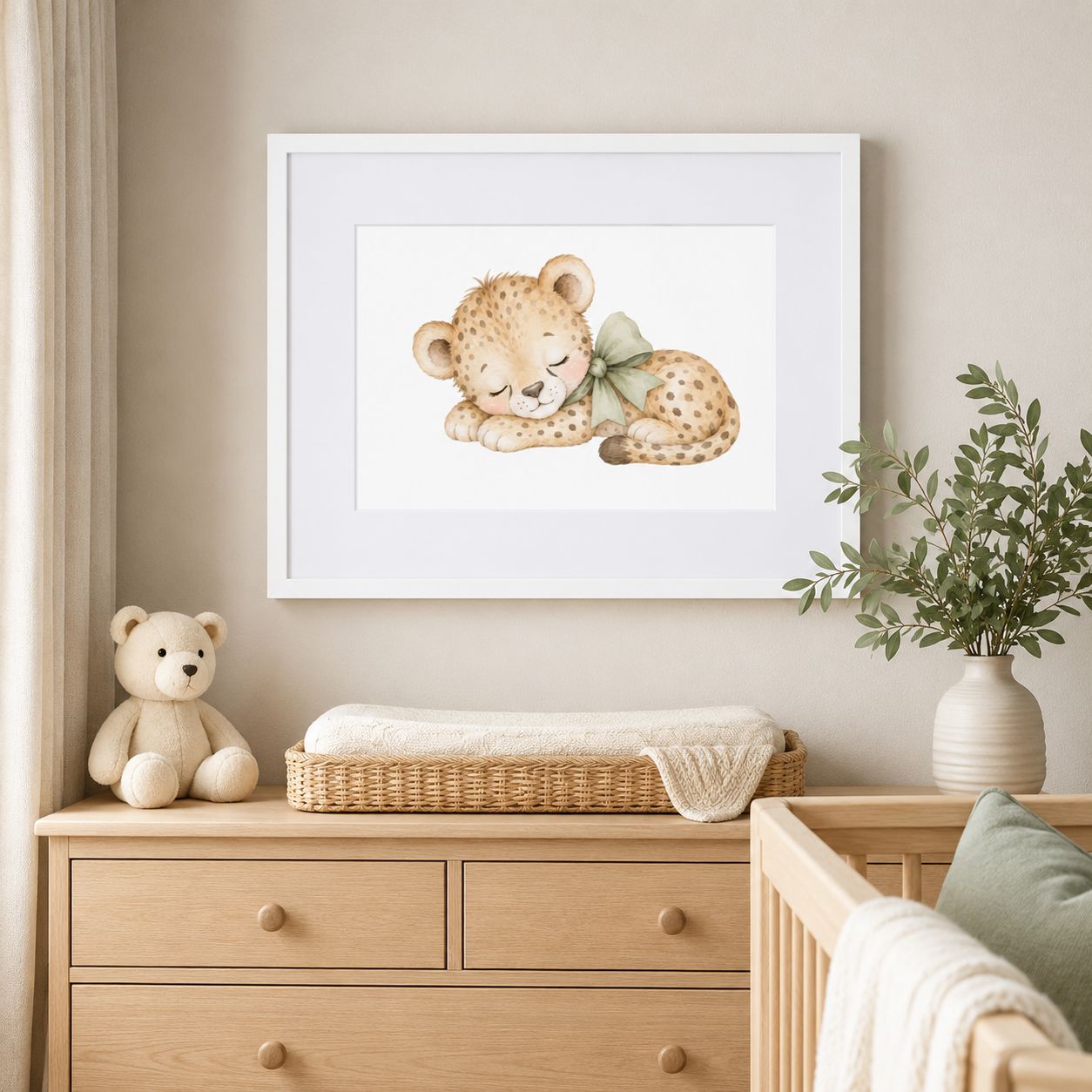 White framed sleeping baby cheetah nursery print displayed above a natural wood changing table in a neutral nursery.
