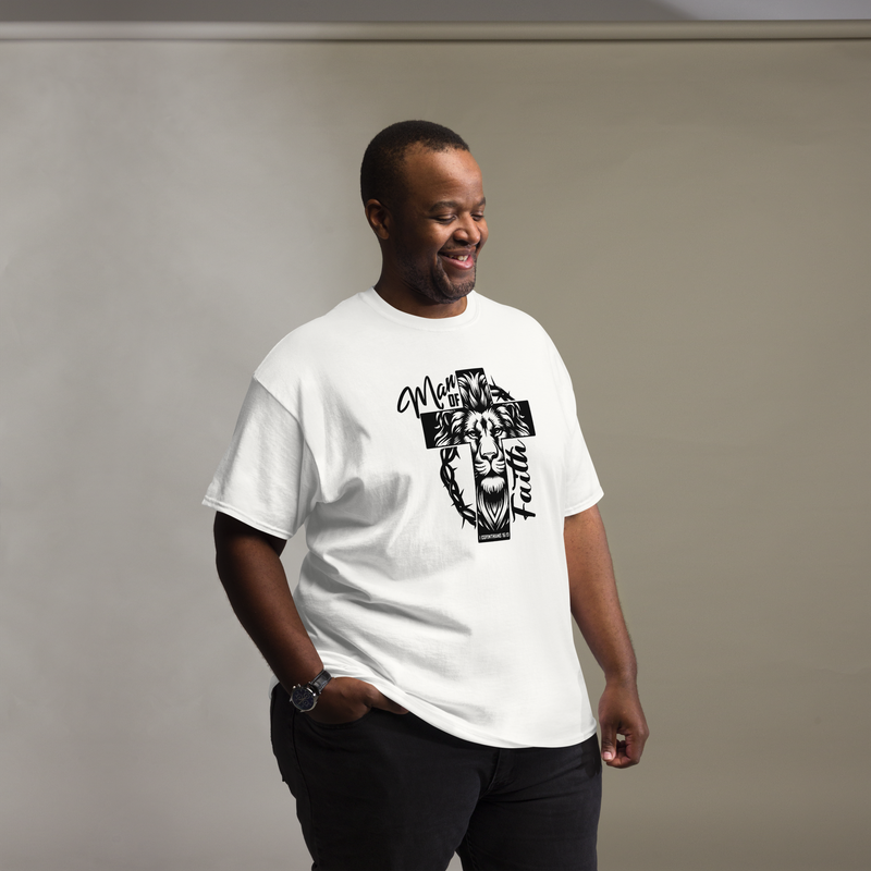 Smiling Black man wearing a white Man of Faith lion and cross Christian graphic T-shirt.