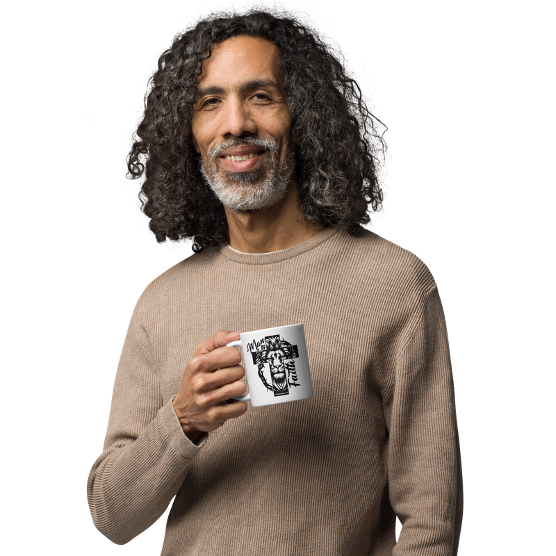 Smiling middle-aged man holding a white 11 oz Man of Faith Christian lion and cross mug.