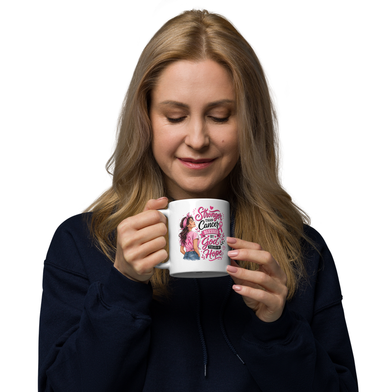 Middle-aged woman holding a white 11 oz breast cancer awareness mug with a pink Christian hope design.
