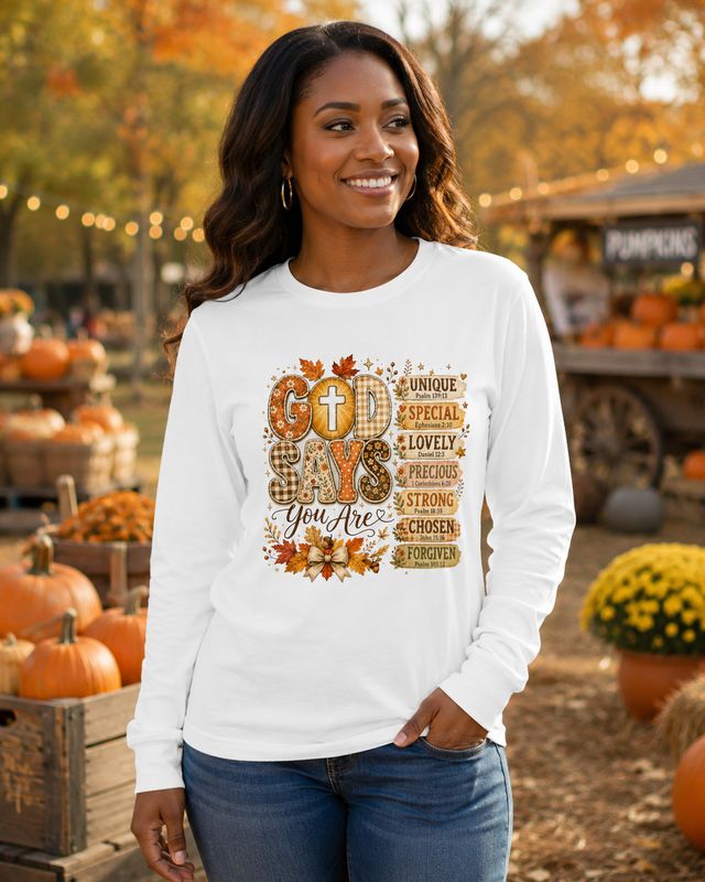 Black woman wearing a white God Says You Are Christian long-sleeve shirt at a fall pumpkin patch.