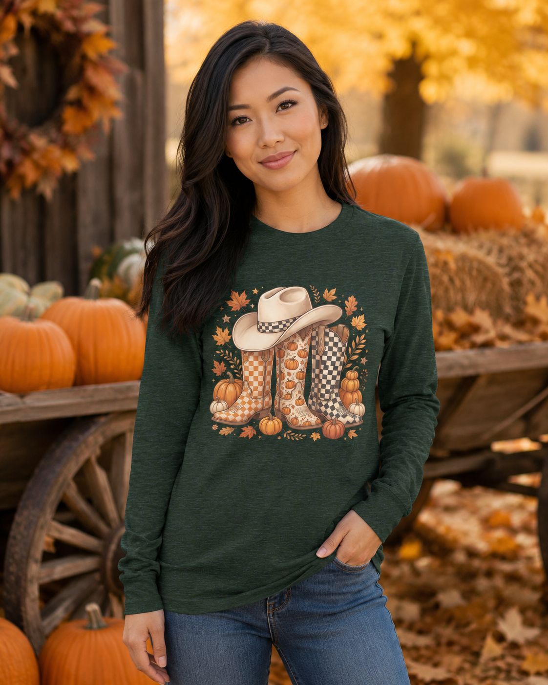 Asian woman wearing a heather forest cowboy boots and pumpkins long sleeve shirt at a fall farm.