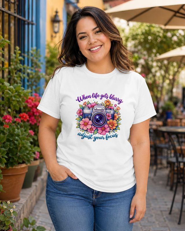 Curvy Latina woman wearing a white floral camera T-shirt with the inspirational “Adjust your focus” photography quote.