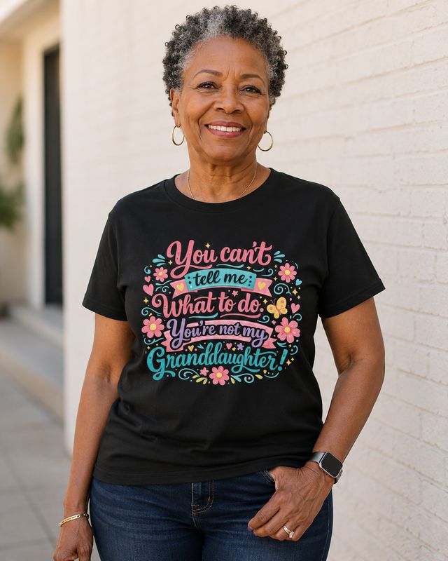Older Black woman modeling a black “You’re Not My Granddaughter” graphic T-shirt outdoors.