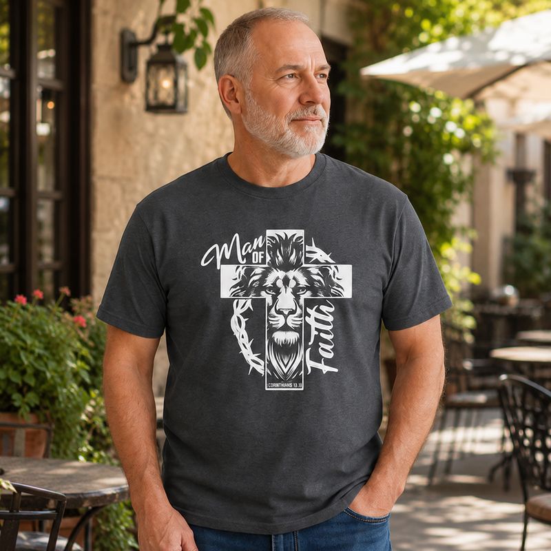 Older man wearing a dark heather Man of Faith lion cross Christian T-shirt on a sunny patio.