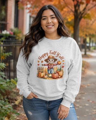 Ash: Curvy Latina woman wearing an ash gray Happy Fall Y’all scarecrow sweatshirt on a tree-lined autumn sidewalk.