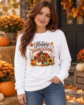 Woman wearing white Happy Thanksgiving turkey long sleeve shirt with pumpkins and fall floral design in autumn setting