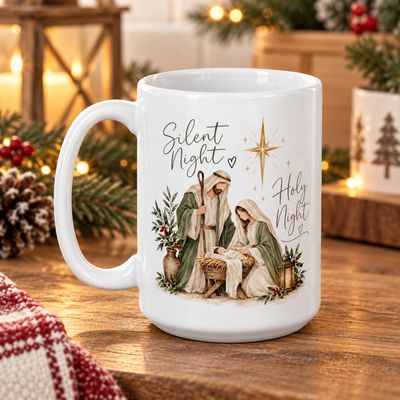 White 15 oz Silent Night Holy Night ceramic Christmas mug featuring a Nativity scene with Mary, Joseph, and baby Jesus, displ