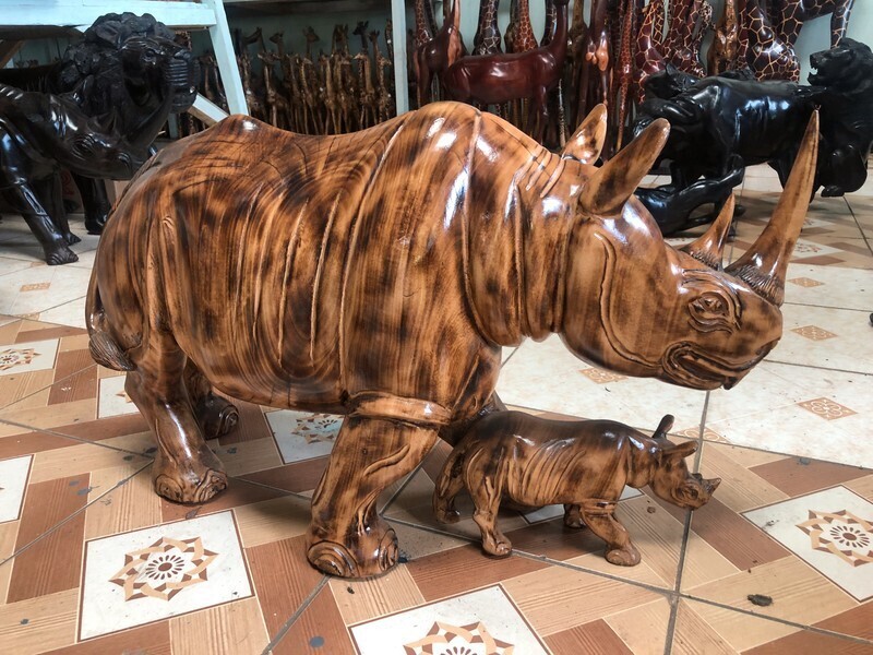 Mother rhino and calf curving