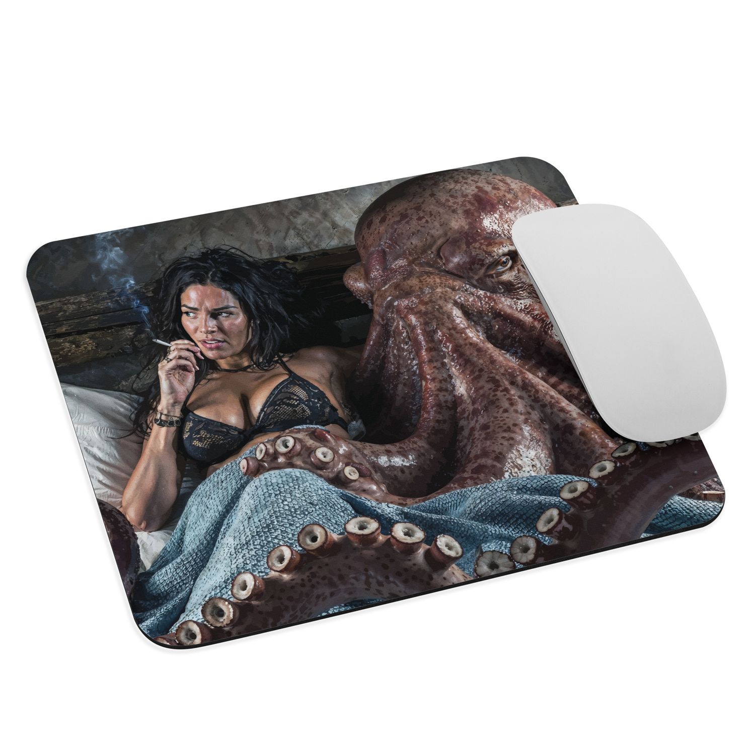 A joke gift, a mousepad with mouse. The image on the pad is of a smoking woman and an octopus in bed, potentially lovers. 