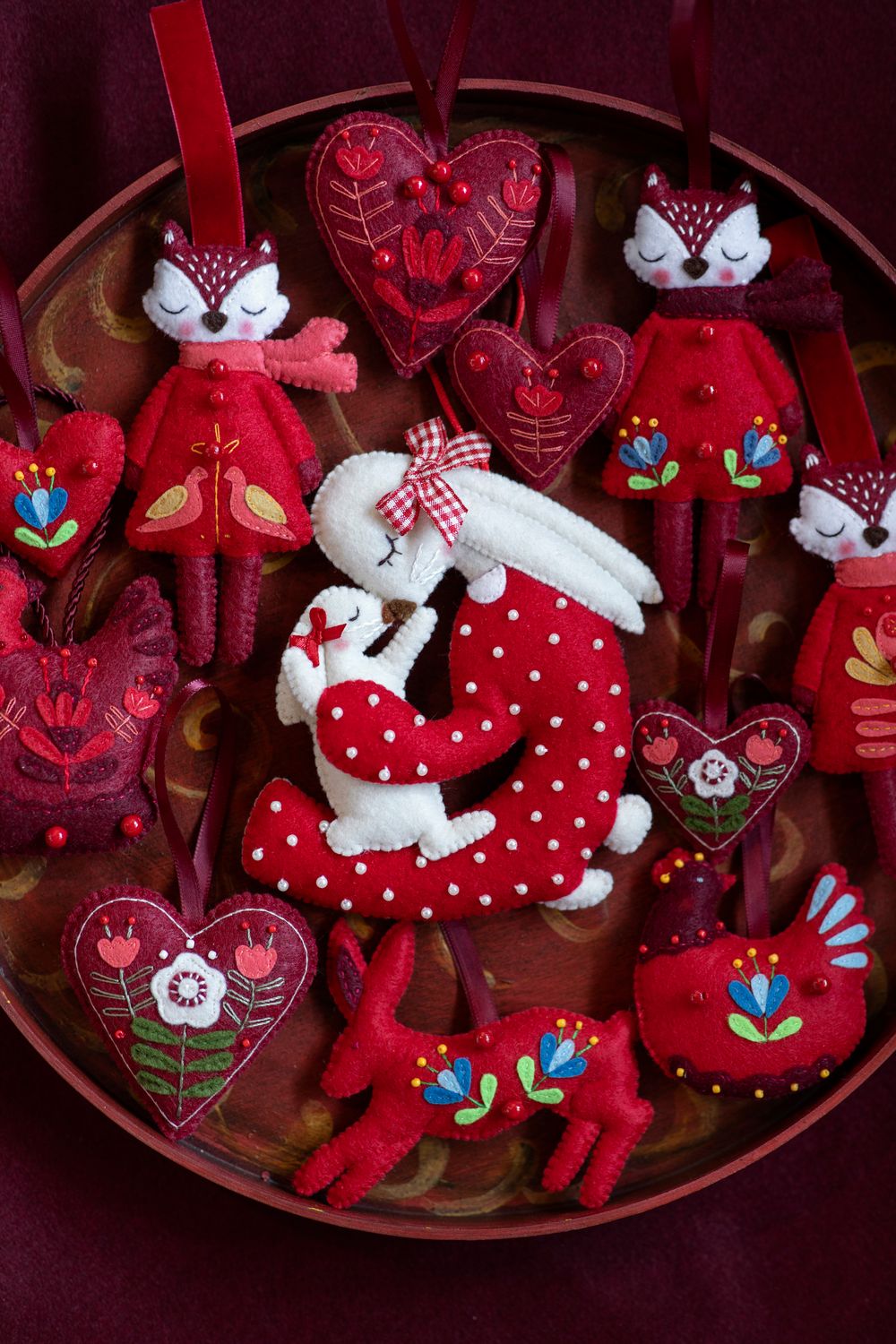 Rabbit holding a baby handmade felt decoration.