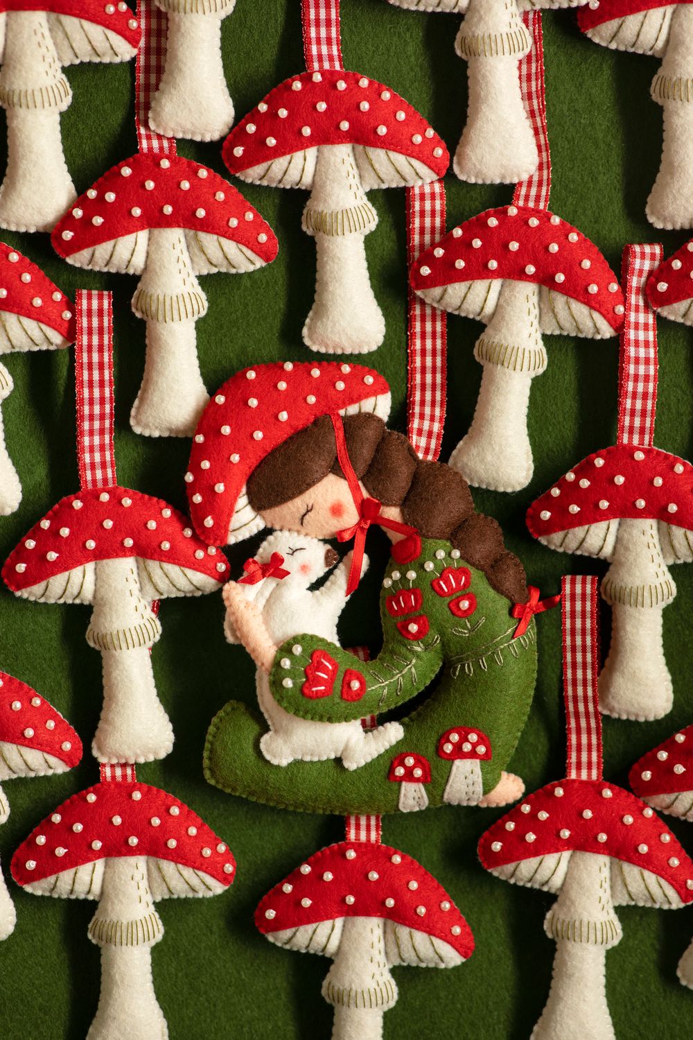 Girl holding a rabbit handmade felt decoration
