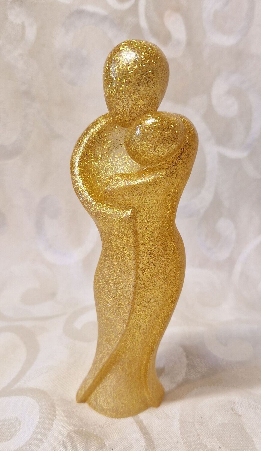 ​Mutter mit Baby in Gold-Glitzer