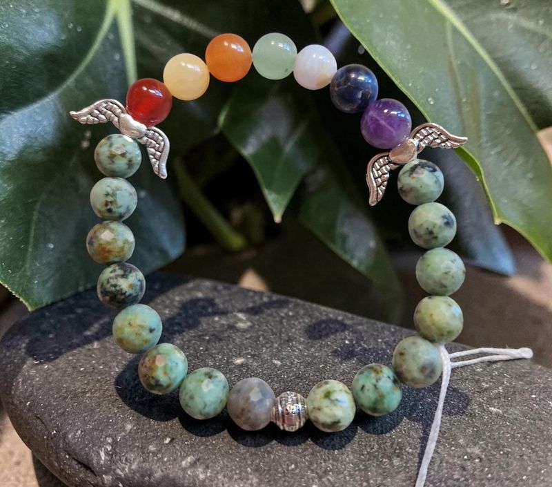 Chakra Armband - Türkis facetiert in A Qualität - Afrika - silberfarbene Engelflügel - 8 mm