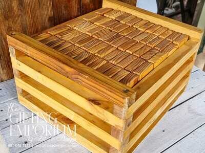 Wooden Lawn Jenga game set with custom engraving on each block, stacked on a grassy lawn.
