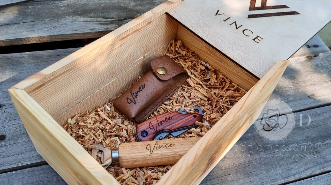 "Elite Groomsman Gift Box featuring a handcrafted wood box, personalized wooden bottle opener, pocket knife, and leather pouch