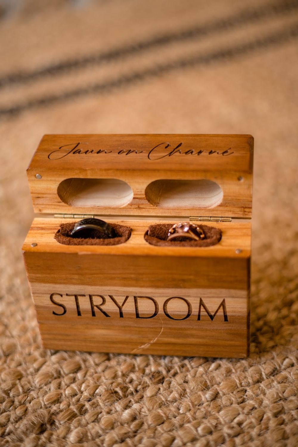 "Personalized wooden ring box with custom engraving, designed to stand upright."
