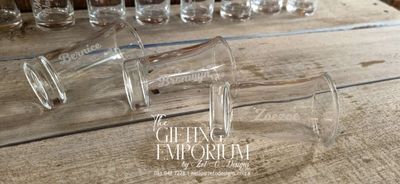 "A pair of 'Take a Shot, We've Tied the Knot' shot glasses with playful text."

