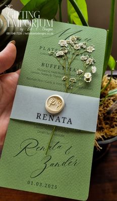 Custom wedding menu printed on premium card stock, featuring a delicate baby’s breath design and finished with a hand-applied